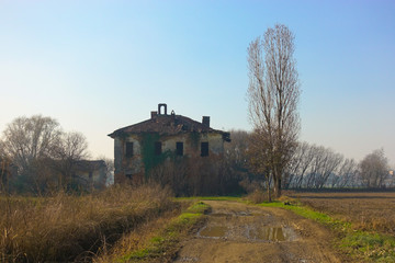 Fototapeta na wymiar Abandoned old rural building in a sunny day