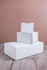 white cardboard boxes on wood