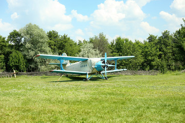 Fototapeta na wymiar Old airplane on green grass
