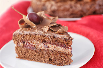 Delicious chocolate cake with cherry on plate