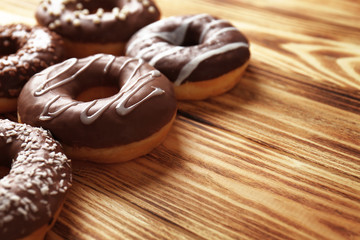 Tasty donuts on wooden table