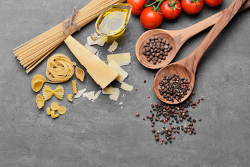Pasta and products on color background