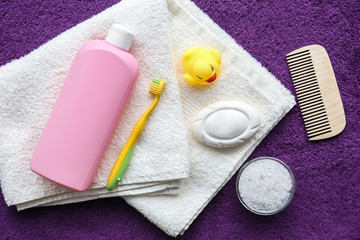 Fototapeta na wymiar Baby accessories for bathing on towel, flat lay