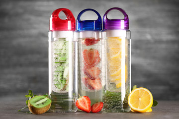 Healthy detox water with fruits on grey background
