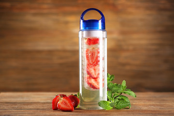 Healthy detox water with fruits on table