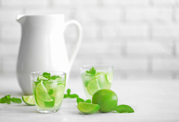 Fresh lime cocktail on brick wall background