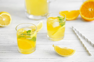 Lemonade and fresh fruits on wooden background
