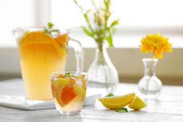 Citrus cocktail on table on blurred window background