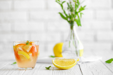 Fresh citrus cocktail on blurred brick wall background