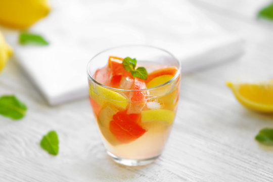 Fresh citrus cocktail on wooden background