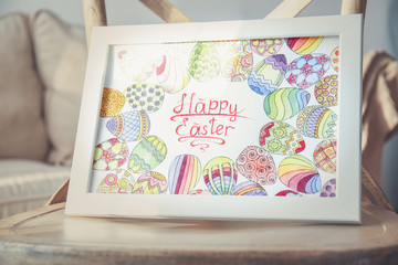 Closeup view of Easter greeting card in light frame on wooden chair