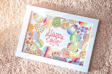 Easter greeting card in light frame lying on carpet