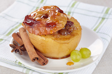 Apple baked with honey, nuts and raisins