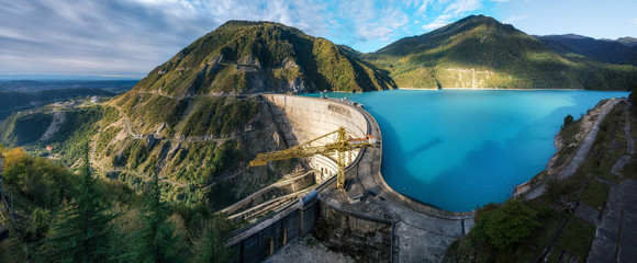 The Enguri hydroelectric power station HES. The wide Inguri River Jvari Reservoir next to Enguri Dam, surrounded by mountains, Upper Svaneti, Georgia. One of the highest concrete arch dam in the world - obrazy, fototapety, plakaty