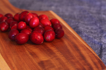 Cranberries on a wooden chopping board
