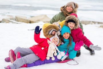 Fototapeta na wymiar Group of young girls on the frozen lake