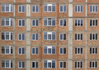 Fototapeta na wymiar New building without facing. Red brick wall