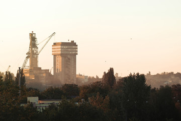 Artem-1 mine head frame in the forest at sunset