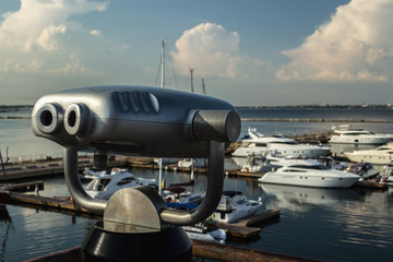 Close up observation deck and sea port with yachts out of focus