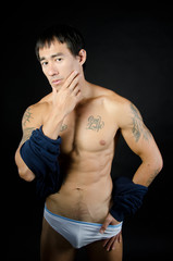 Naklejka premium Manly Asian guy shirtless with tattoos.