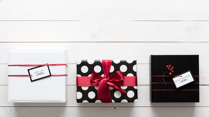 Many elegant and beautifully wrapped black, red and white christmas presents