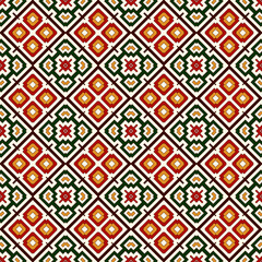 Seamless pattern in Christmas traditional colors. Repeated squares and rhombuses bright ornamental abstract background.