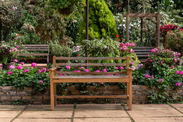 wooden table set in a flower garden