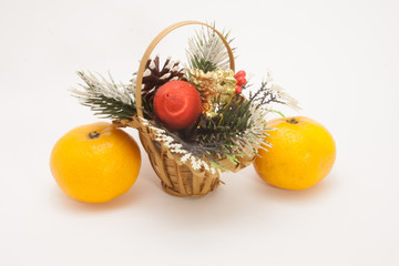 Christmas basket and two ripe tangerine isolated on white background

