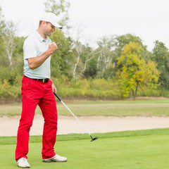 Golfer. Golfer makes the putting shot