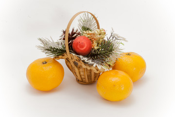 Christmas basket and three ripe tangerine isolated on white background
