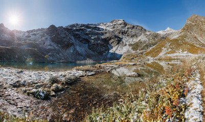 Alpine lake at the sunset at autumn. Arkhyz, Karachay-Cherkessia, Greater Caucasus, Russia.