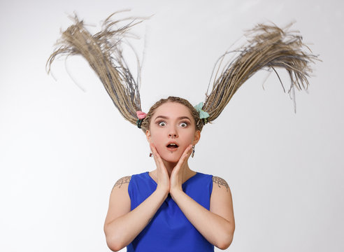 Surprised young woman long dreads.
