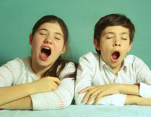 brother and sister yawning close up portrait