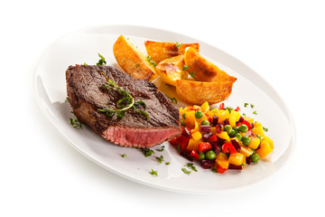Grilled steak, baked potatoes and vegetable salad on white background 