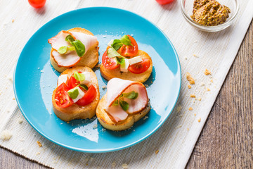 Bruschetta with tomato, cheese and bacon