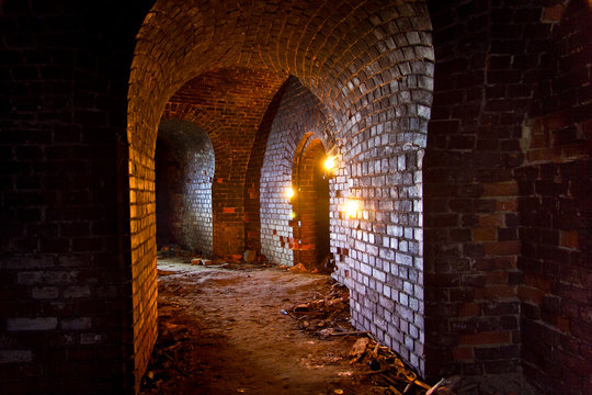 Dungeon Under The Old German Fortress Illuminated By Lantern And Candles