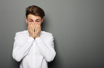 Sad businessman over grey background
