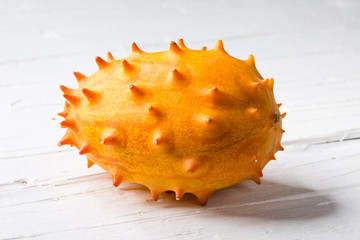 Kiwano on white wooden background