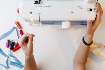 Seamstress preparing work on sewing-machine
