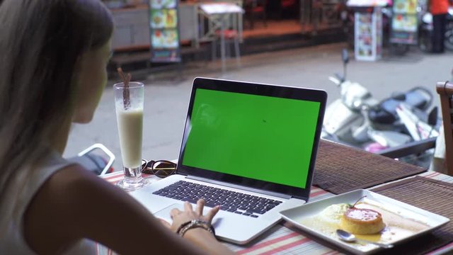 Student Using Laptop While Sitting At Cafe