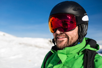 Happy skier with large oversized ski goggles