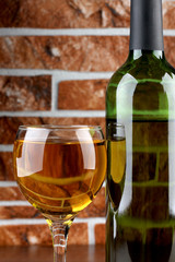 Glass and bottle wine on wooden table
