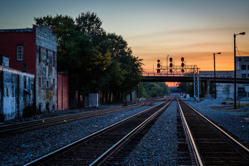 Fototapeta na wymiar Railroad tracks at sunset, in downtown Greensboro, North Carolin