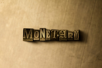 MONETARY - close-up of grungy vintage typeset word on metal backdrop. Royalty free stock - 3D rendered stock image.  Can be used for online banner ads and direct mail.