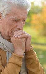 Sad elderly man outdoors