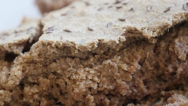 Brown staple food served on plate slow pan 4K 2160p 30fps UltraHD footage - Crust of rustic bread made from full healthy grain and barley 3840X2160 UHD panning video