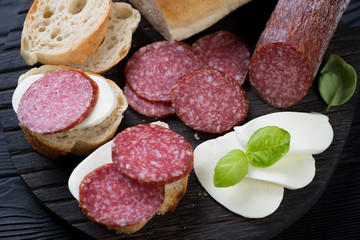 Close-up of bruschettas with smoked sausage and mozzarella