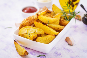 Ruddy Baked potato wedges with rosemary and garlic on a light background