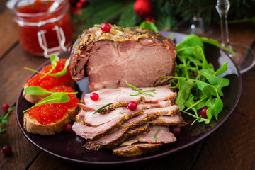 Christmas baked ham and red caviar, served on the old wooden table.