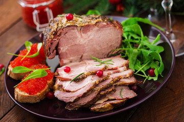 Christmas baked ham and red caviar, served on the old wooden table.